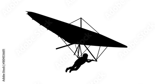 Silhouette of a person hang gliding, soaring through the air, enjoying flight.