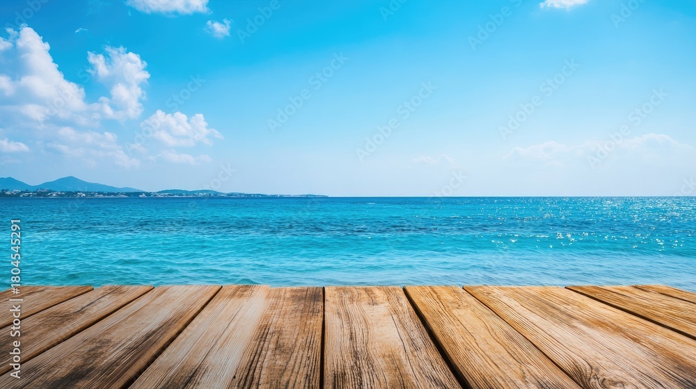 Fototapeta premium Peaceful seaside view with wooden deck against bright blue ocean and clear sky, ideal for relaxation and vacation imagery, capturing tranquility and beauty