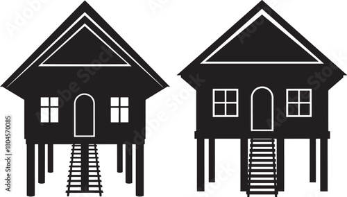 Two traditional stilt houses in silhouette