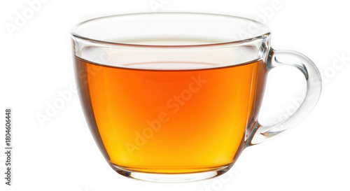 A clear glass cup filled with amber liquid on a black background