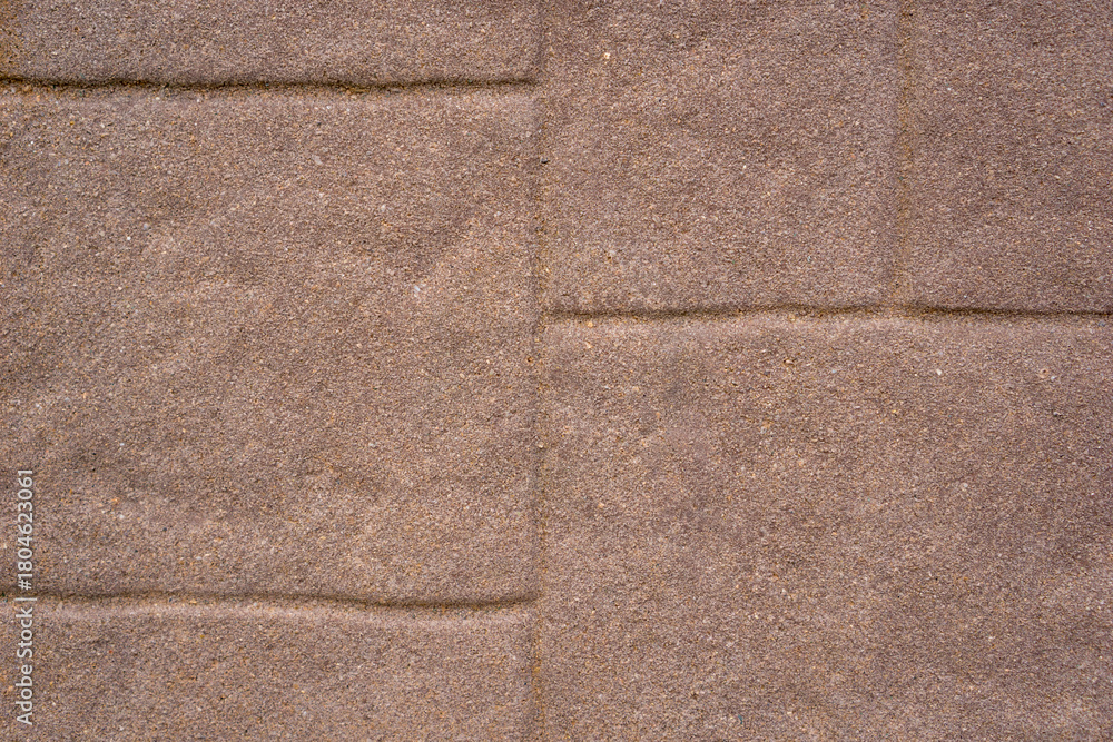 Fototapeta premium textured brown concrete paving stones with defined mortar lines, close-up uniform pattern, concept of construction, building material, landscaping