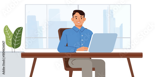 Man working on a laptop at his desk in an office