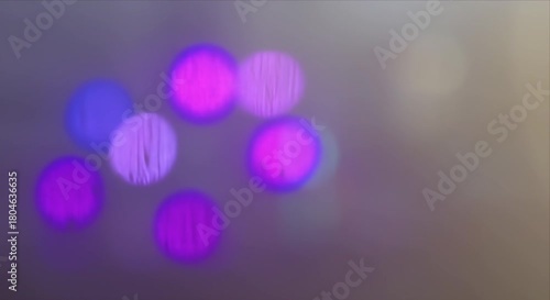 Raindrops trickling down glass with soft colorful light bokeh in the background, creating a calming motion