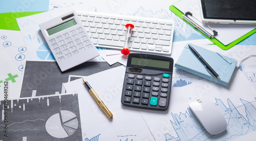 Pen and calculator on a financial graphs. Business