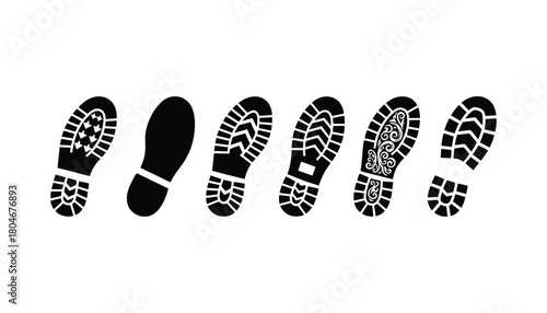 Various shoe prints in black displayed on a white background surface