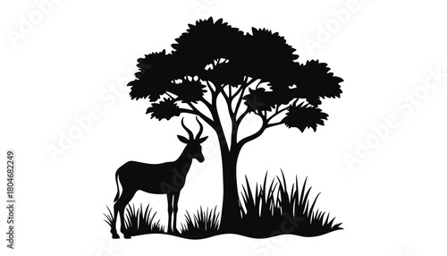 Silhouette of an antelope standing near a tree in black and white art