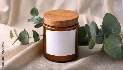ceramic candle jar mockup with wood lid and blank label on beige linen with eucalyptus branch