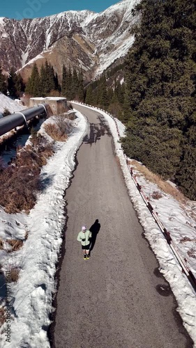 Man running at the road in the mountains