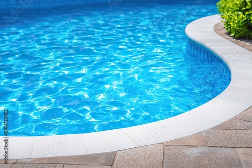 Serene swimming pool with crystal clear water and white border.