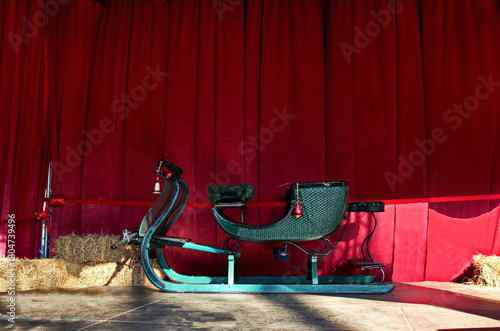 A magnificent festive corner with a sleigh, straw and red curtains for greetings, wishes and gift giving on Christmas and New Year, Sofia, Bulgaria 