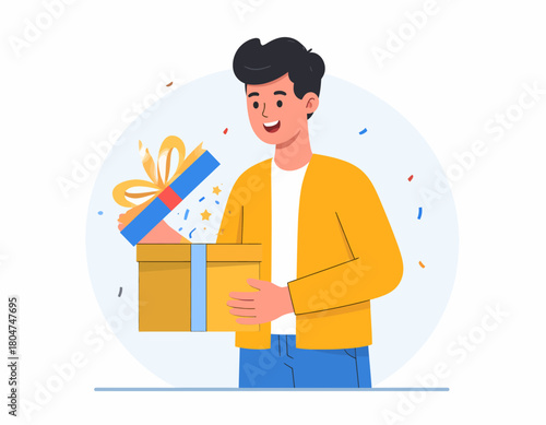 A young man smiles as he opens a gold gift box with a blue ribbon and yellow bow, confetti floating around him.