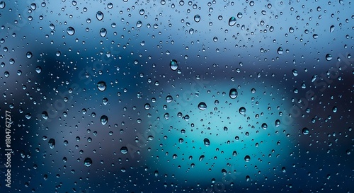 Close-up of Rain Droplets on Glass Window with Blue Background