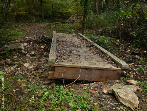 Footbridge askew from flood, damaged and swept away