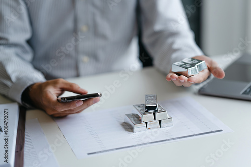 Businessman reviews silver market charts for investment opportunities