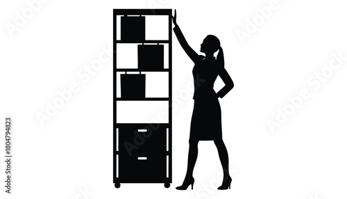 Silhouette woman reaching for files on office storage cabinet
