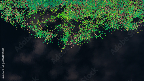 Top-down aerial photo of vibrant green and multicolored floating leaves scattered over dark, calm water, creating a striking natural abstract pattern