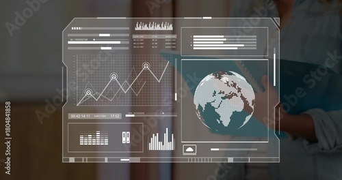 Displaying holo HUD in office, showing charts and globe, teen in denim holding blue tablet right