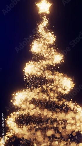 Glowing golden particles form Christmas tree shape with star on top against dark background