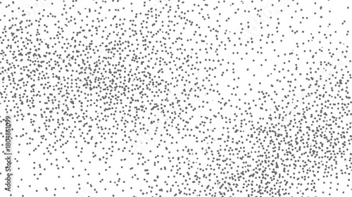 A scattered pattern of small dark gray dots on a white background fading from dense to sparse texture