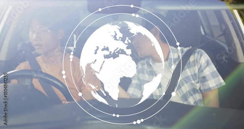 Driver holding wheel and passenger pointing as globe tech appearing expanding after dash touch