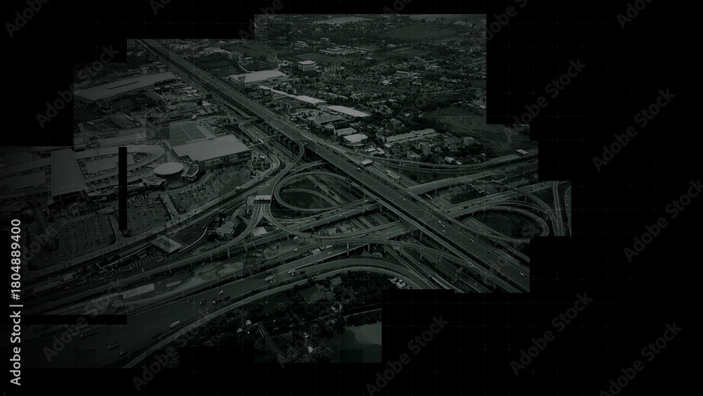 Fototapeta premium Aerial surveillance, military reconnaissance view of a complex highway interchange with HUD targeting graphics, creating a cinematic spy-drone atmosphere and intelligence-operation mood