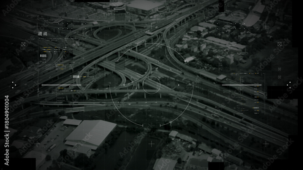 Fototapeta premium Aerial surveillance, military reconnaissance view of a complex highway interchange with HUD targeting graphics, creating a cinematic spy-drone atmosphere and intelligence-operation mood