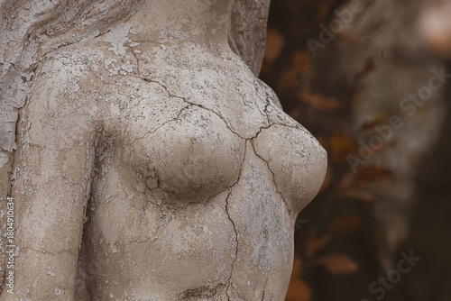 Cracks on a female statue as a symbol of breast cancer prevention. Women's health. Breast cancer. Disease prevention. Female breasts. Timely examination. Symbol of the female body. Work of art.