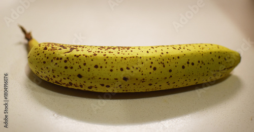 A banana with spots which usually shows a normal sign of ripening