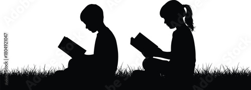 Silhouette of two children sitting on grass reading books outdoors representing education learning childhood study and peaceful moments