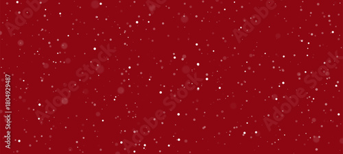 Falling snow effect on a red background with copy space. Winter snowfall pattern for Christmas and New Year greeting card banner.
