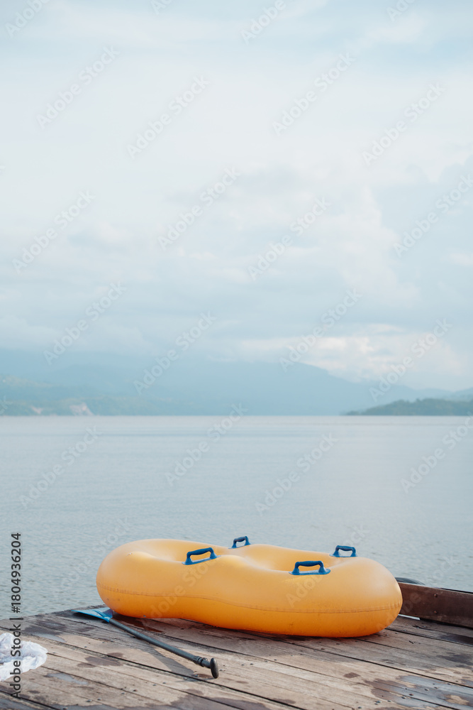 Fototapeta premium double inflatable float on a dock on a beautiful lake surrounded by mountains
