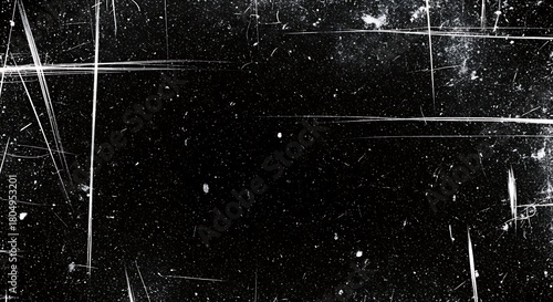 Grungy black background with white scratches and dust particles