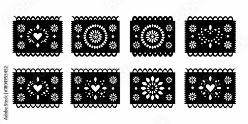 Collection of eight black and white papel picado banners with floral and heart designs