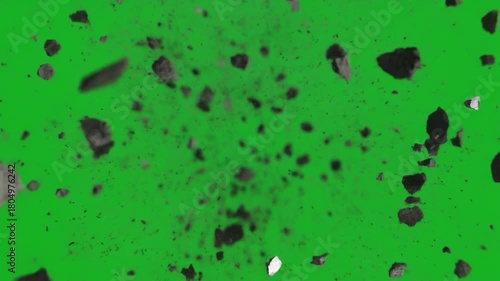Explosive rock and debris fragments flying towards camera on a green screen background for visual effects.