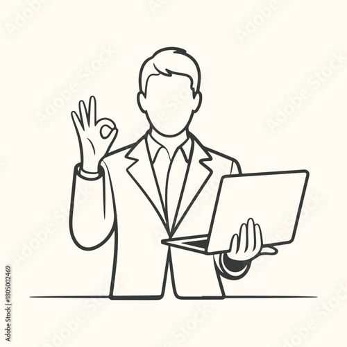 Handsome executive businessman in a suit pointing at you while sitting and holding a laptop in the office