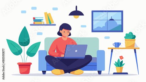 A young woman is comfortably working on her laptop while sitting cross legged on a sofa in a cozy home environment