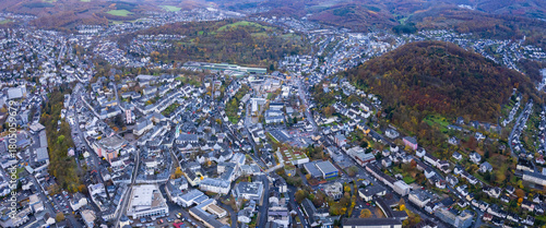 An aerial panorama view above the old town of the city Siegen on an early summer morning in Germany
