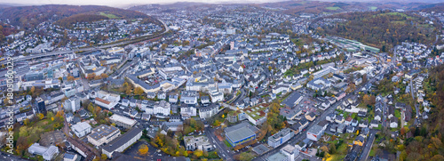 An aerial panorama view above the old town of the city Siegen on an early summer morning in Germany