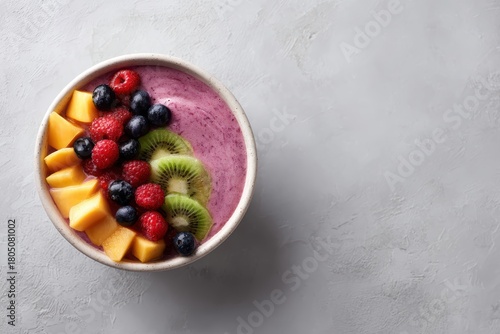 247. plant-based smoothie bowl top view, vibrant fruits, professional tone, natural window light, ample space for text on the right, brand-safe, no logos