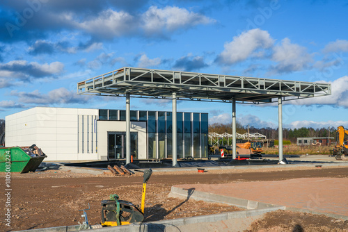 Construction of a modern gas station with steel canopy and service building in final stages