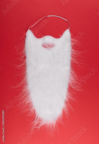 santa claus white beard accessory on a red background