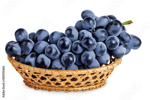 dark blue grape berry bunch in a wicker basket isolated on white background