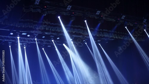 multi-colored beams of stage lighting during a concert