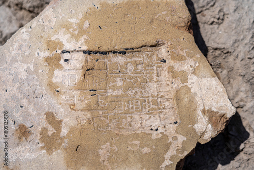 Cuneiform tablets and pottery fragments discovered at an archaeological site in Uruk Iraq, revealing ancient writing techniques