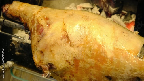 Closeup lamb roasted over a wood fire in a restaurants kitchen