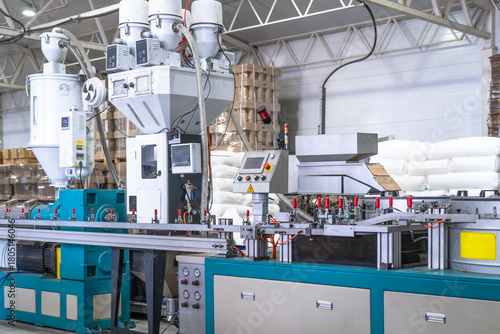 Fotografía Industrial plastic extrusion machine in modern factory, automated production line with control panel, pneumatic system and material feeders, plastic processing equipment for manufacturing