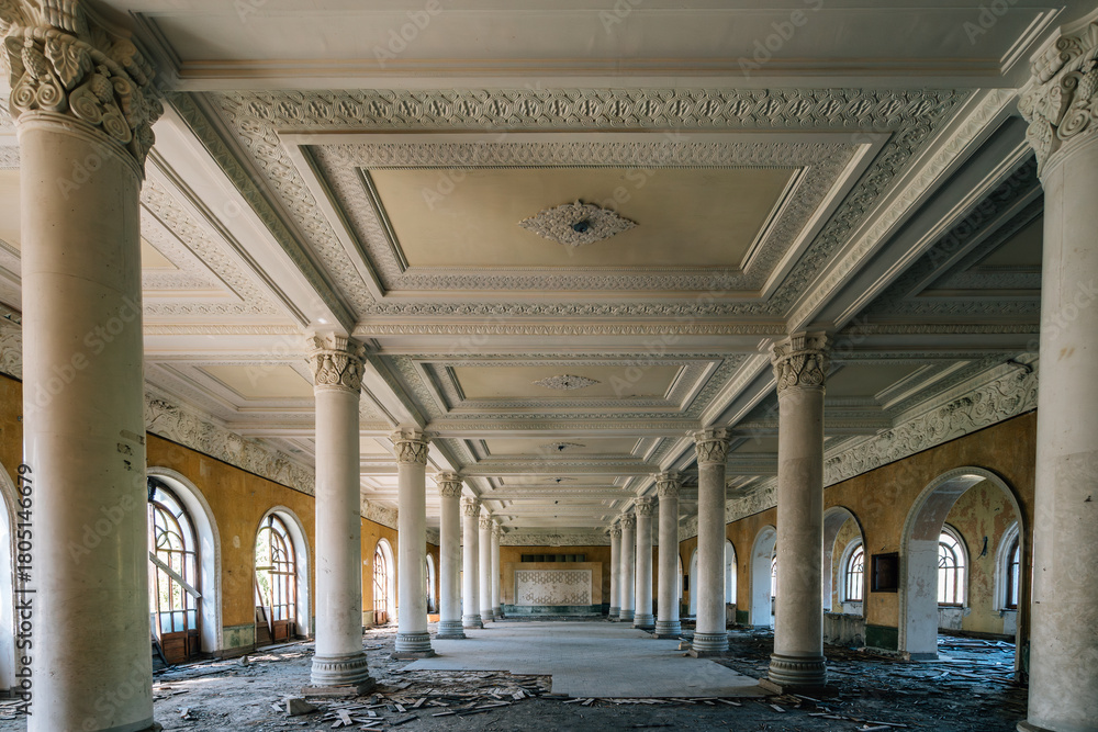 Fototapeta premium Abandoned neoclassical hall with marble columns and ornate ceiling, historic architecture with arched windows, retro textures, decay aesthetics and classical symmetry.