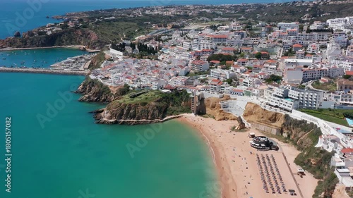 Wallpaper Mural Aerial view of Praia dos Pescadores in Albufeira, Portugal, with sandy beach, turquoise sea, cliffside buildings and beach elevator visible. Concept of coastal tourism and accessible seaside lifestyle Torontodigital.ca