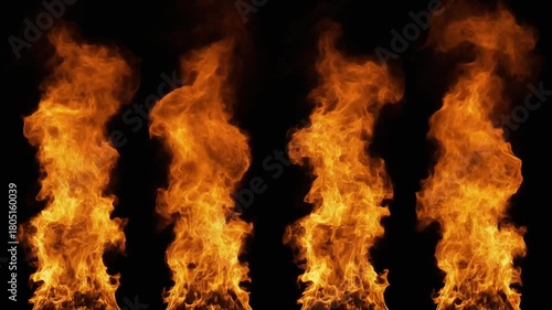 Four isolated columns of orange flames rising against a black background in a studio shot 4k footage