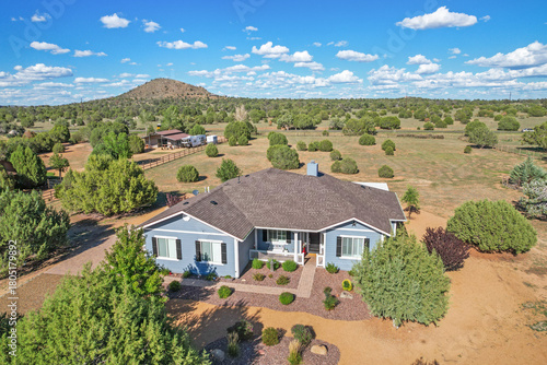 A charming blue house featuring white shutters adorning the windows